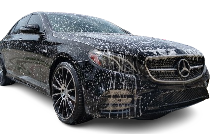 Mercedes car covered in thick white foam during a professional detailing wash.